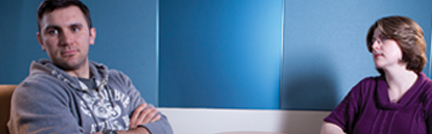 Image of male client and female therapist. The client's arms are crossed and he is looking away from the therapist, disgruntled. Image of male client and female therapist. The client's arms are crossed and he is looking away from the therapist, disgruntled.