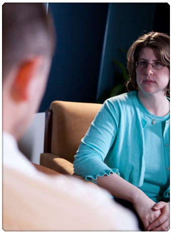 Image of therapist from over the client's shoulder. Therapist has blank stare. Image of therapist from over the client's shoulder. Therapist has blank stare.