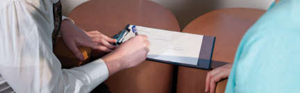 Image of patient writing on clipboard. Image of patient writing on clipboard.