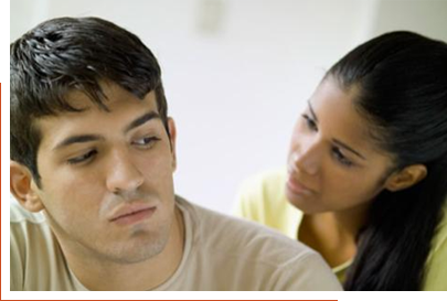 Young couple sitting together with the man's back to the woman
