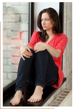 Woman sitting next to a window