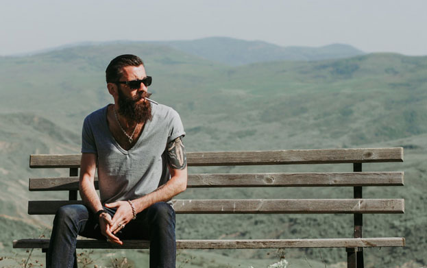 Veteran sitting on bench with rolling hills in the background