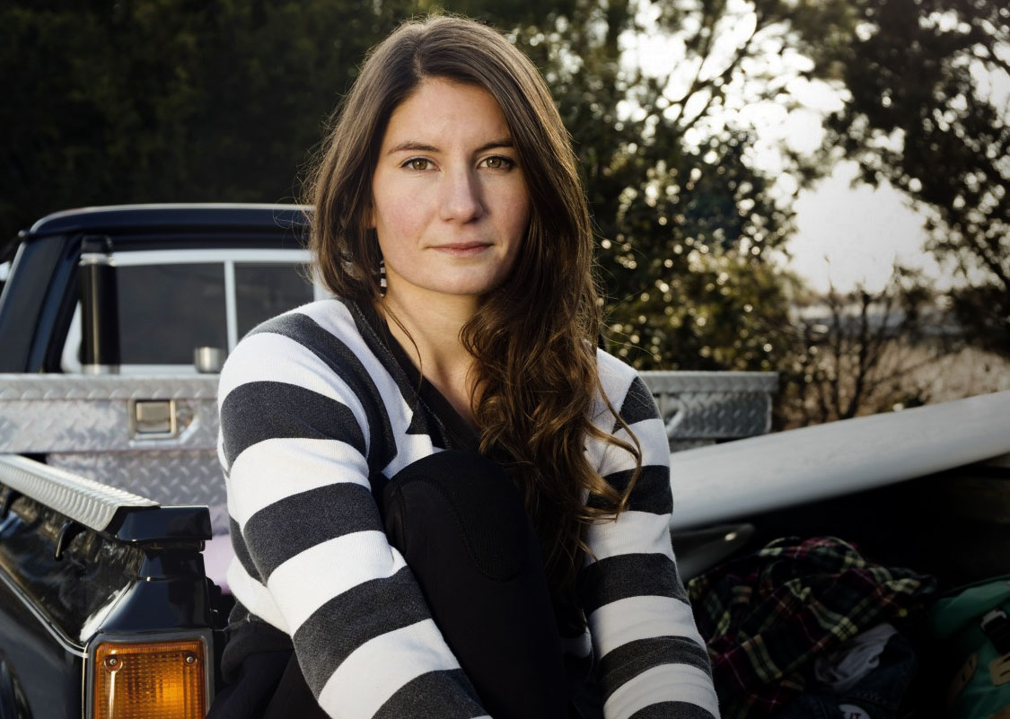 Woman sitting on a truck