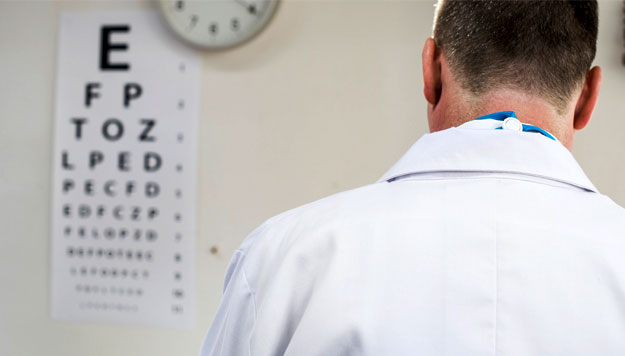 Eye doctor facing snellen chart