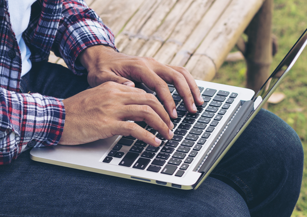 Veteran typing on a laptop